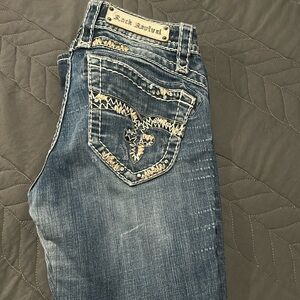 Rock Revival Blue Boot Cut Jeans with Distinctive Embellishments